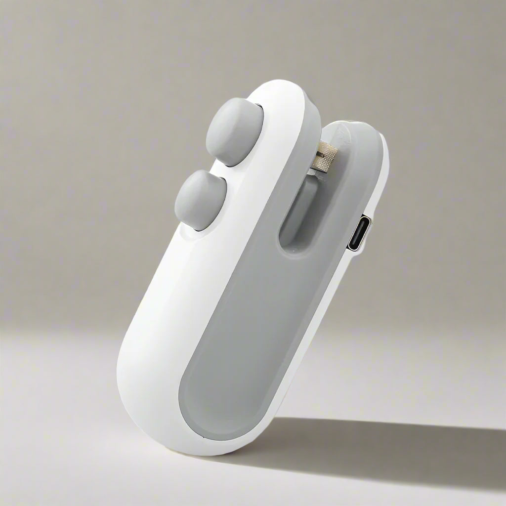 The OWOW Me Mini heat sealer magnet clip for snack bags in white stands upright on a neutral background, featuring two circular buttons and a charging port.