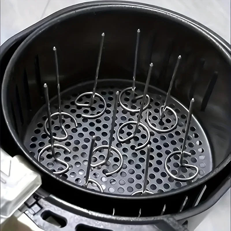 A close-up of the OWOW Me Vertical Stainless Steel Skewer Grill for air fryer shows its black basket and heat-resistant rack with vertical skewers arranged in a grid, perfect for holding foods and easy to clean after use.