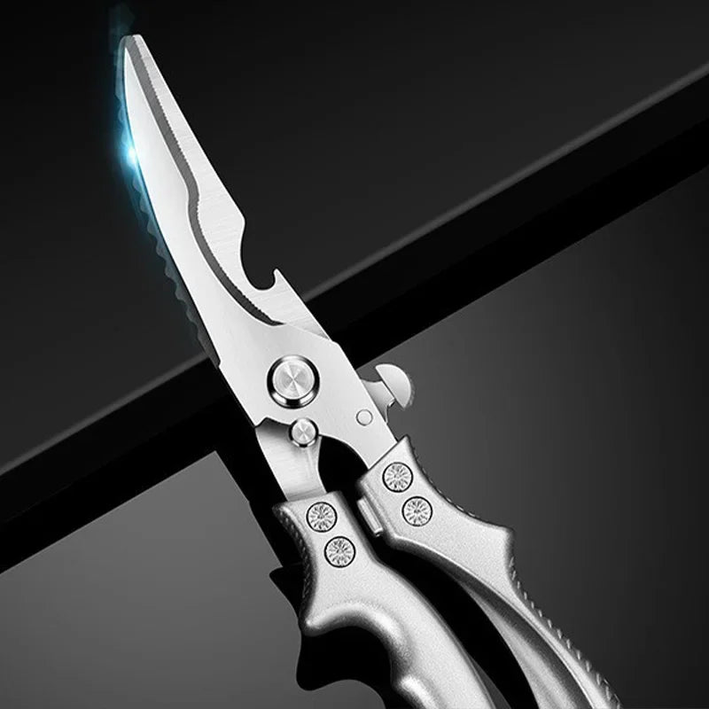 A close-up of OWOW Me Stainless Steel Poultry Bone Cutter Scissors, featuring serrated and straight edges, resting on a glossy black surface.